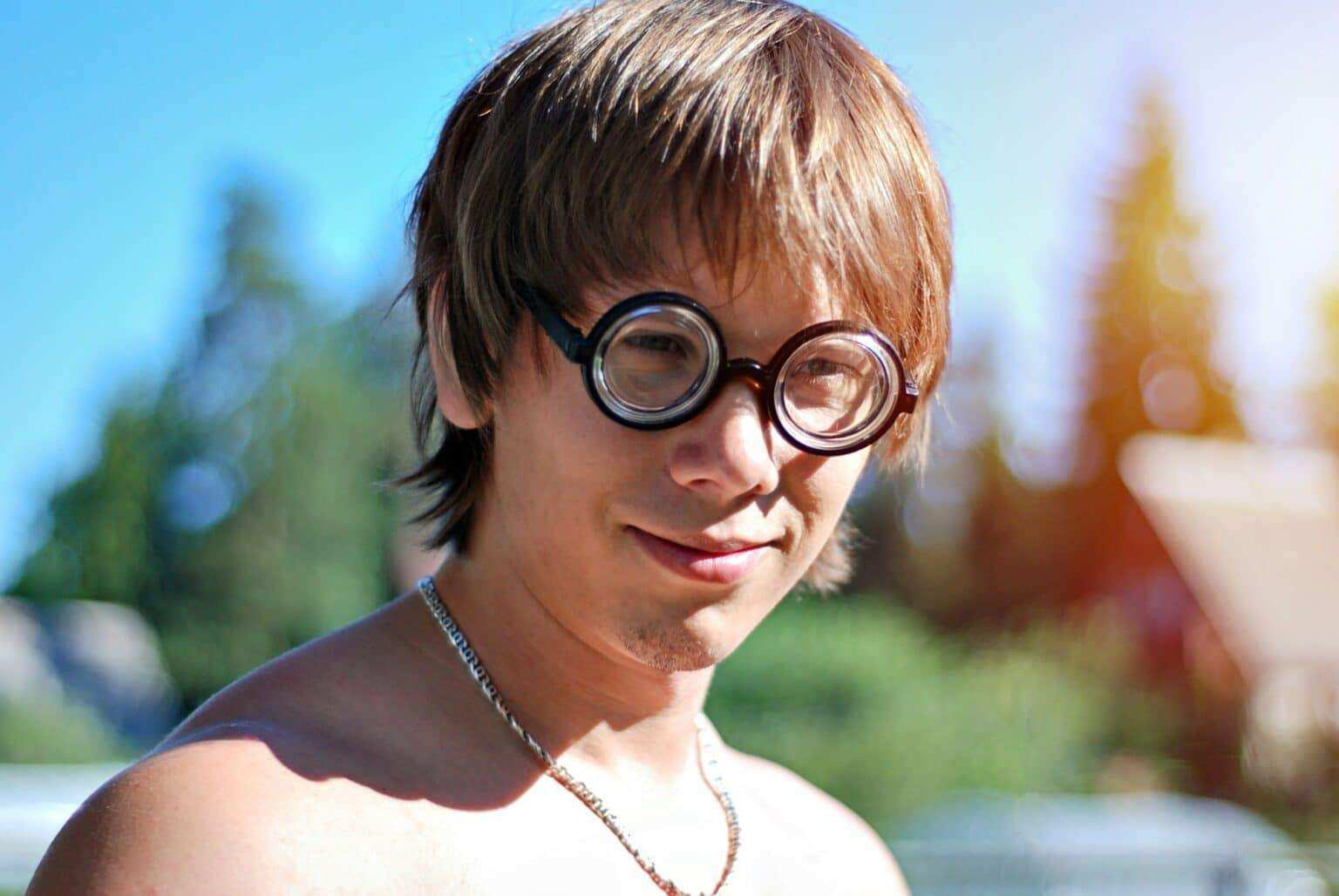 Geek man in round eyeglasses outdoor. Nerd and freak peope