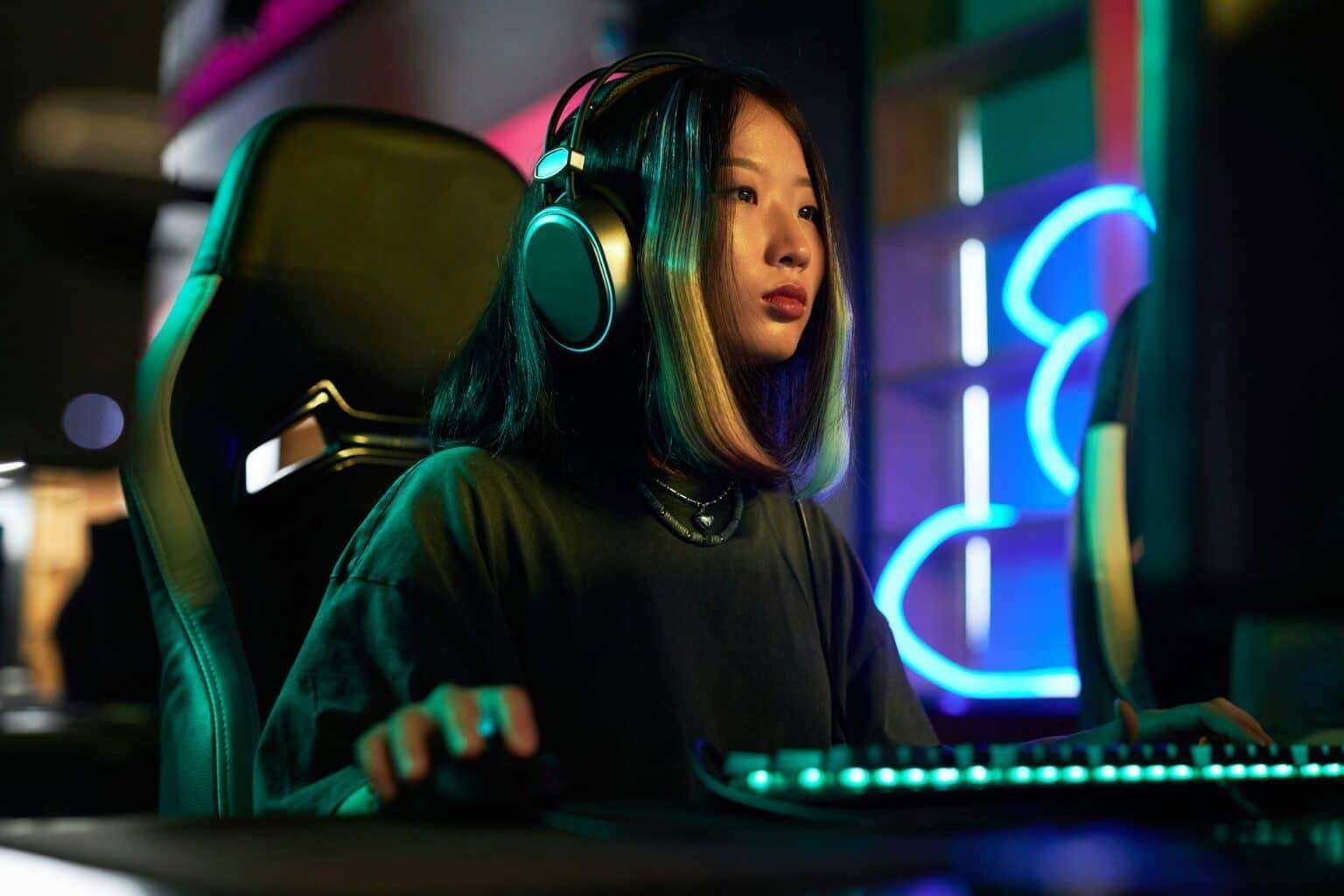 Young Asian Woman Playing Video Games in Neon Lights