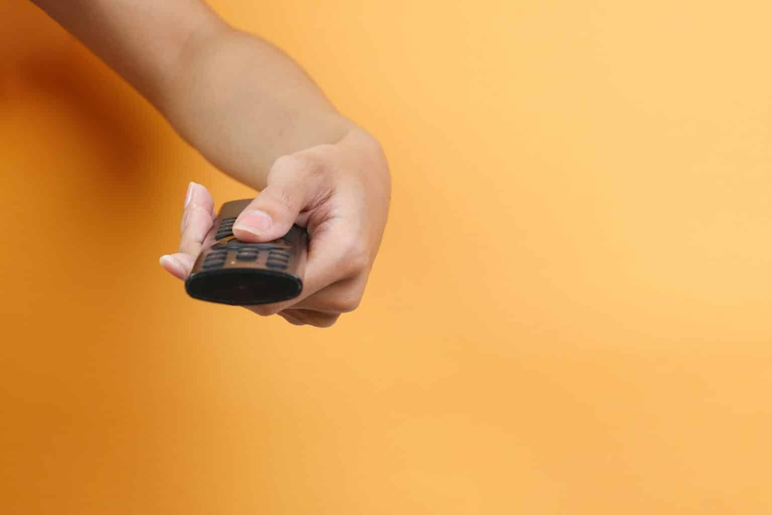 Hand Holds TV Remote