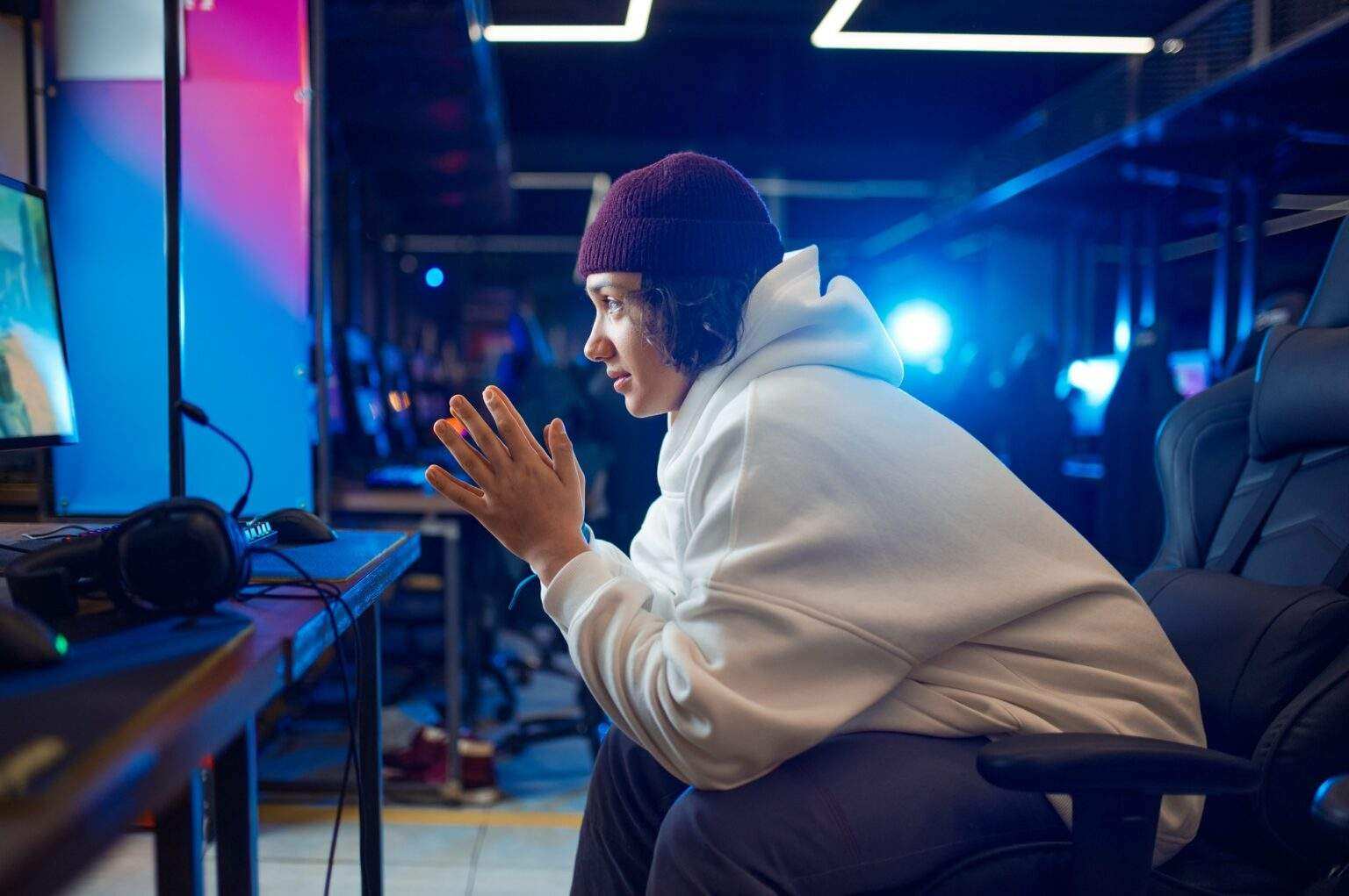 Young gamer resting in gaming armchair, game club