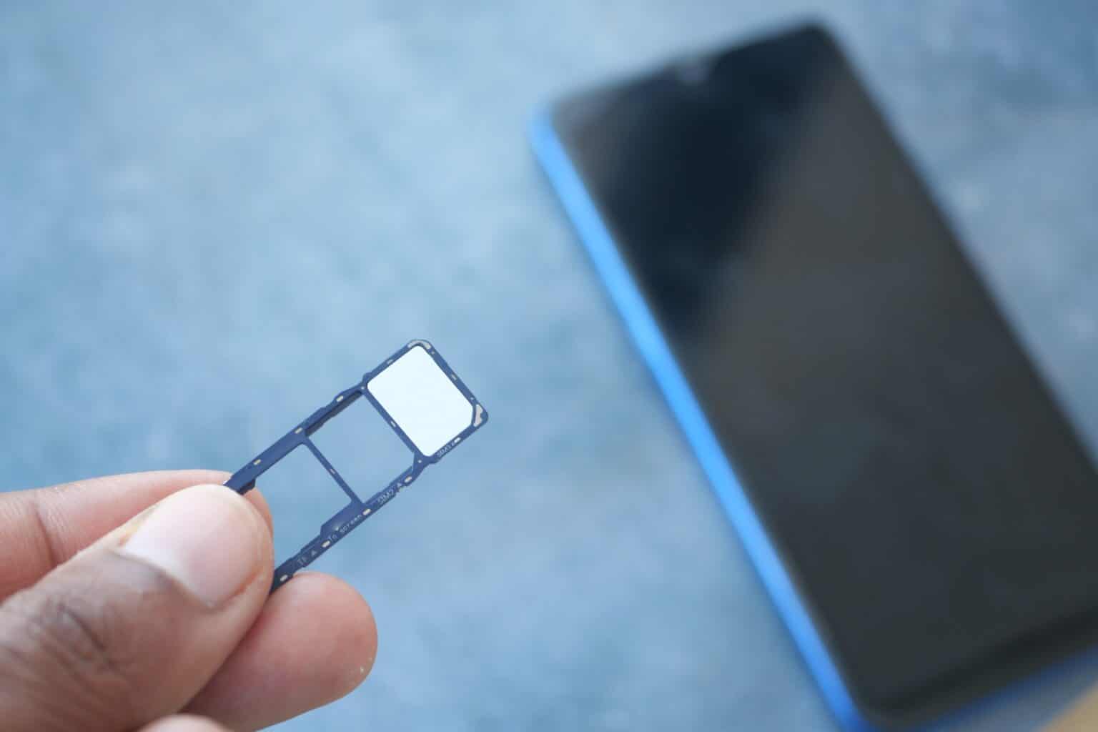 A sim card for a smart phone on finger