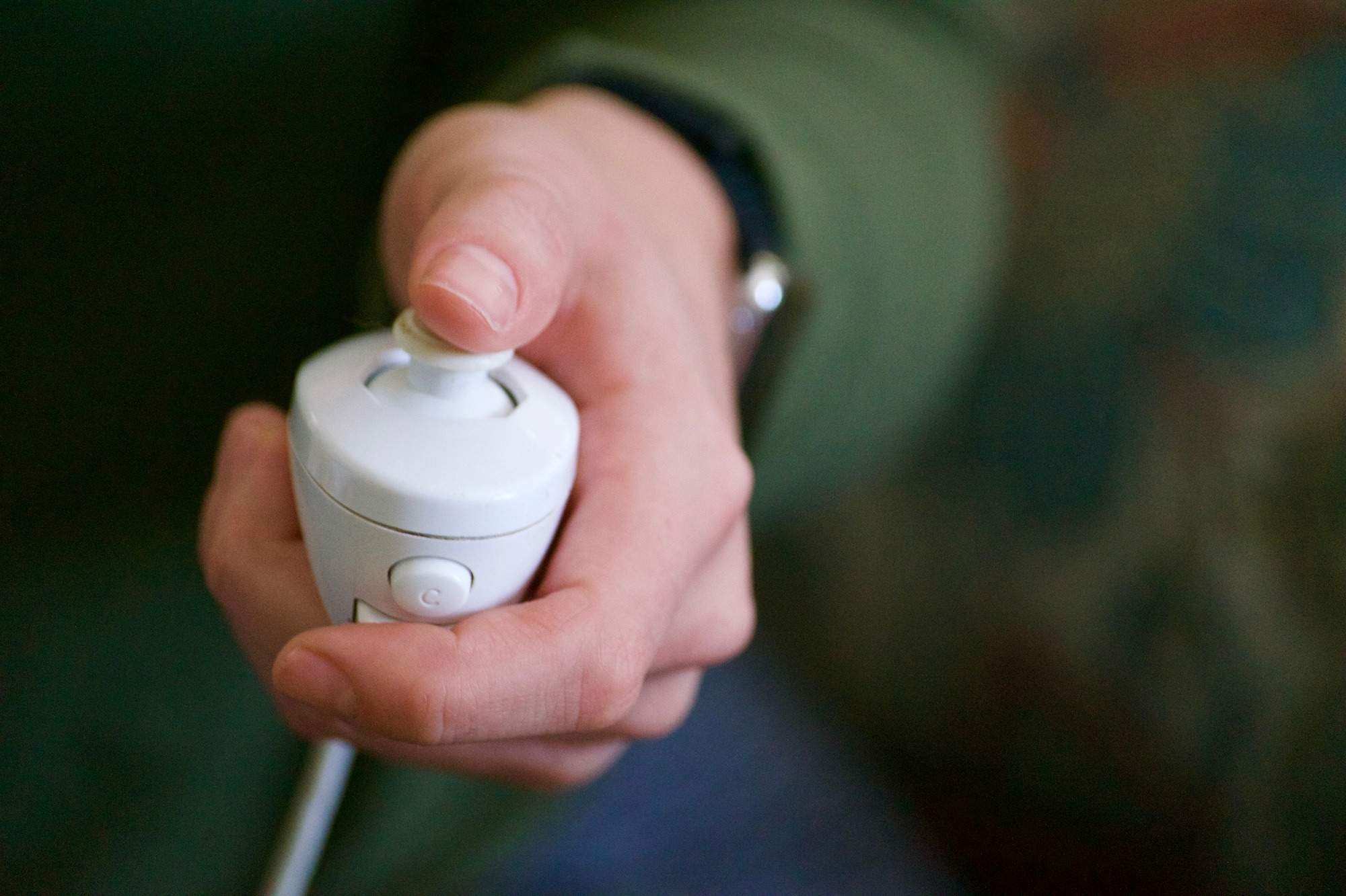 A woman using a video game controller to relax and destress at home while staying indoors, inside