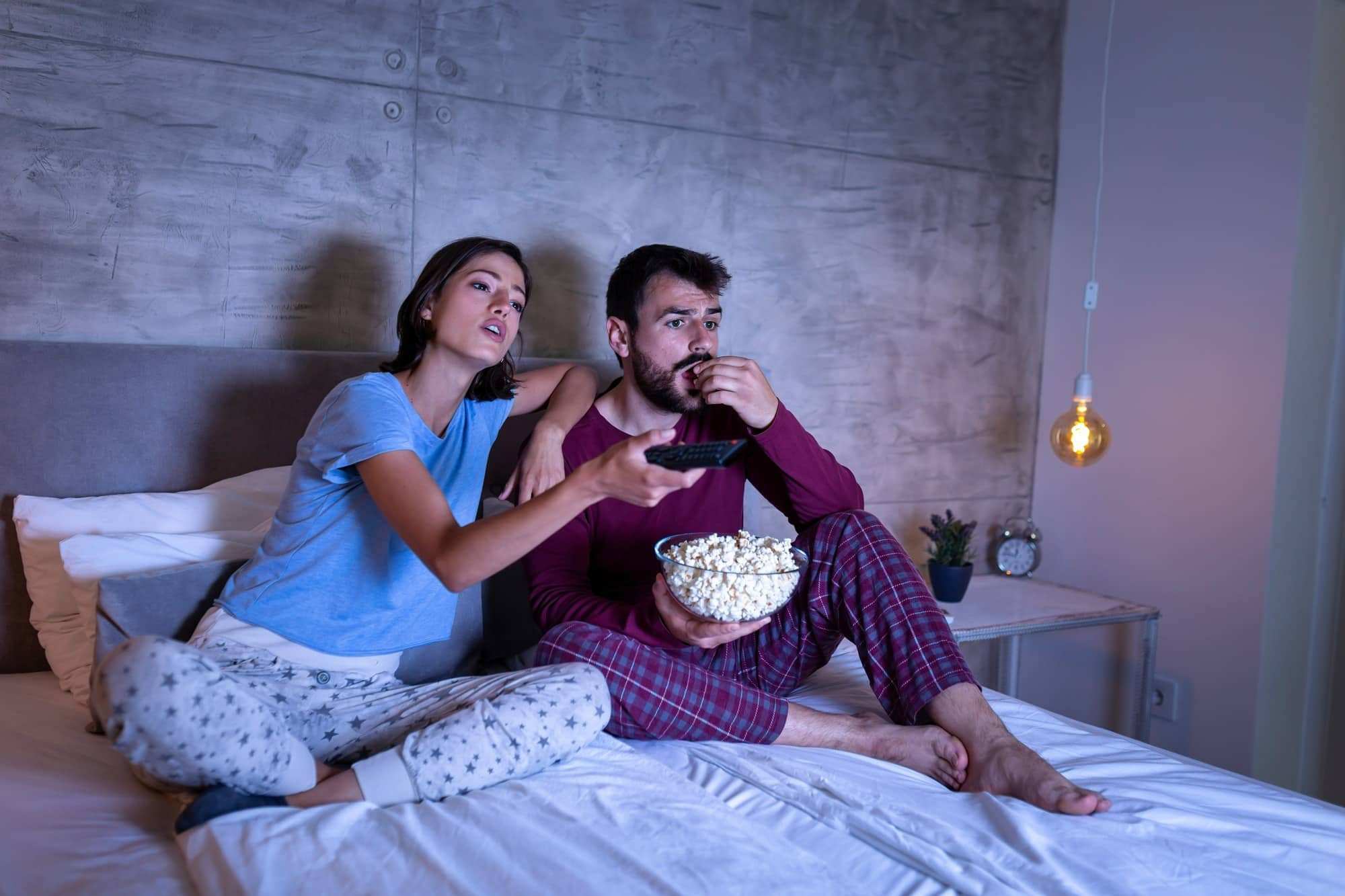 Couple in bed watching TV