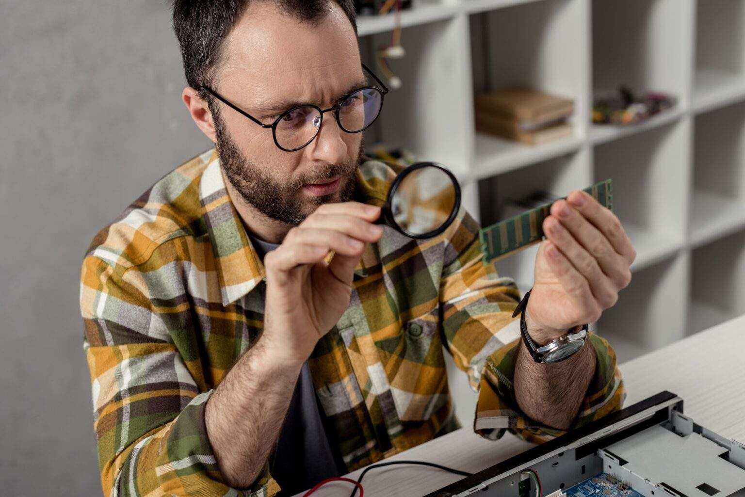 repairman looking on ram and using magnifier
