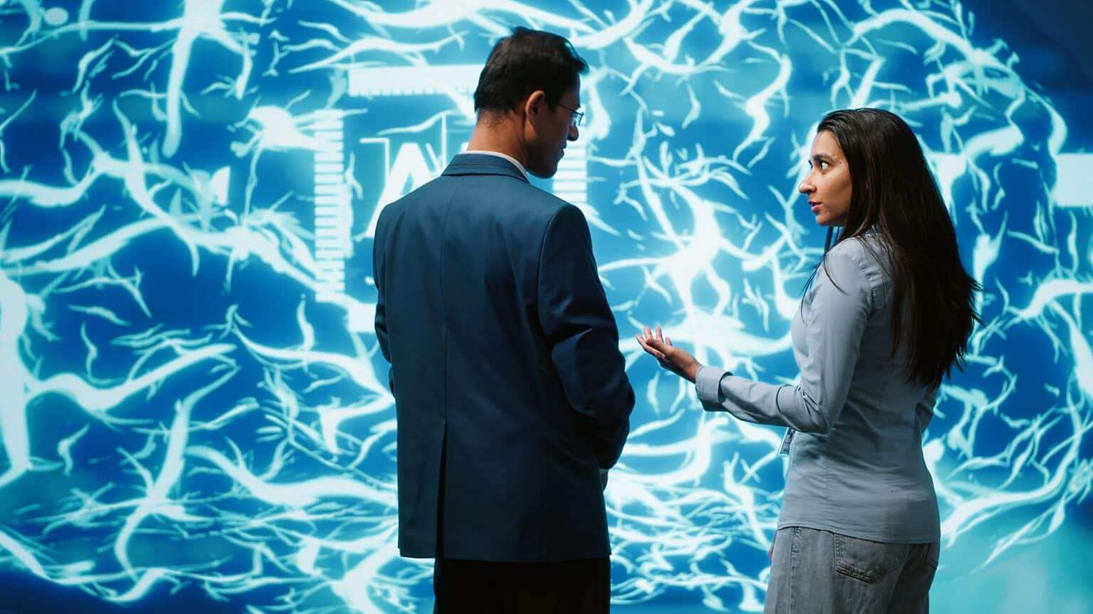 Teamworking colleagues implementing artificial intelligence