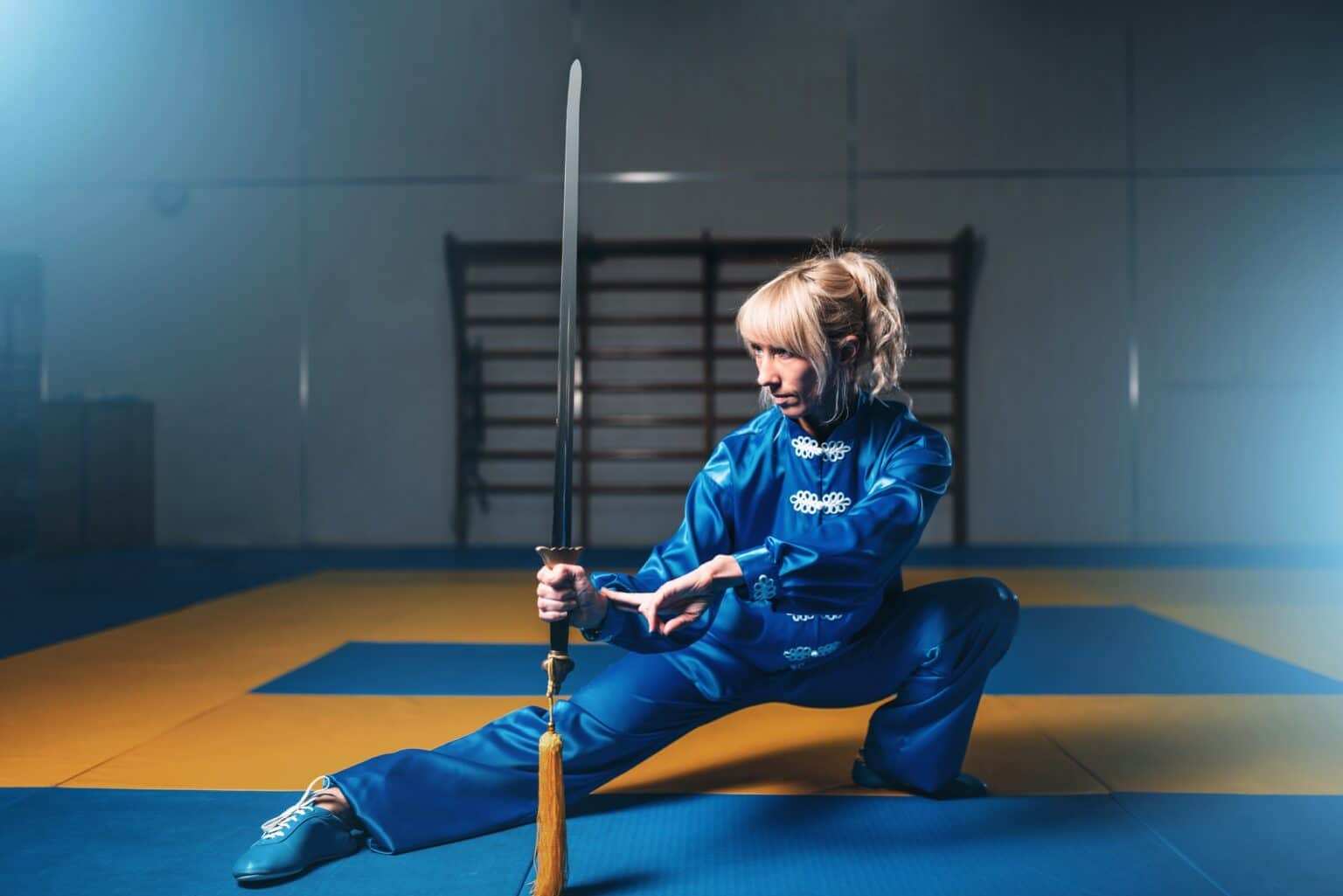 Female wushu fighter with sword in action
