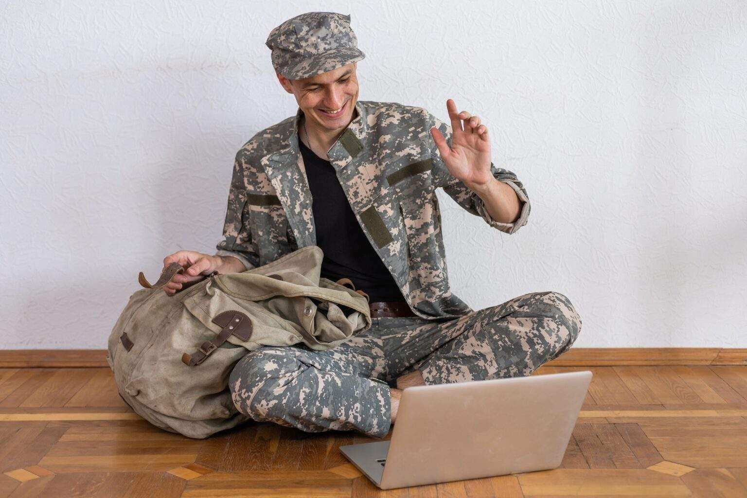 Soldier holding laptop. Military education concept