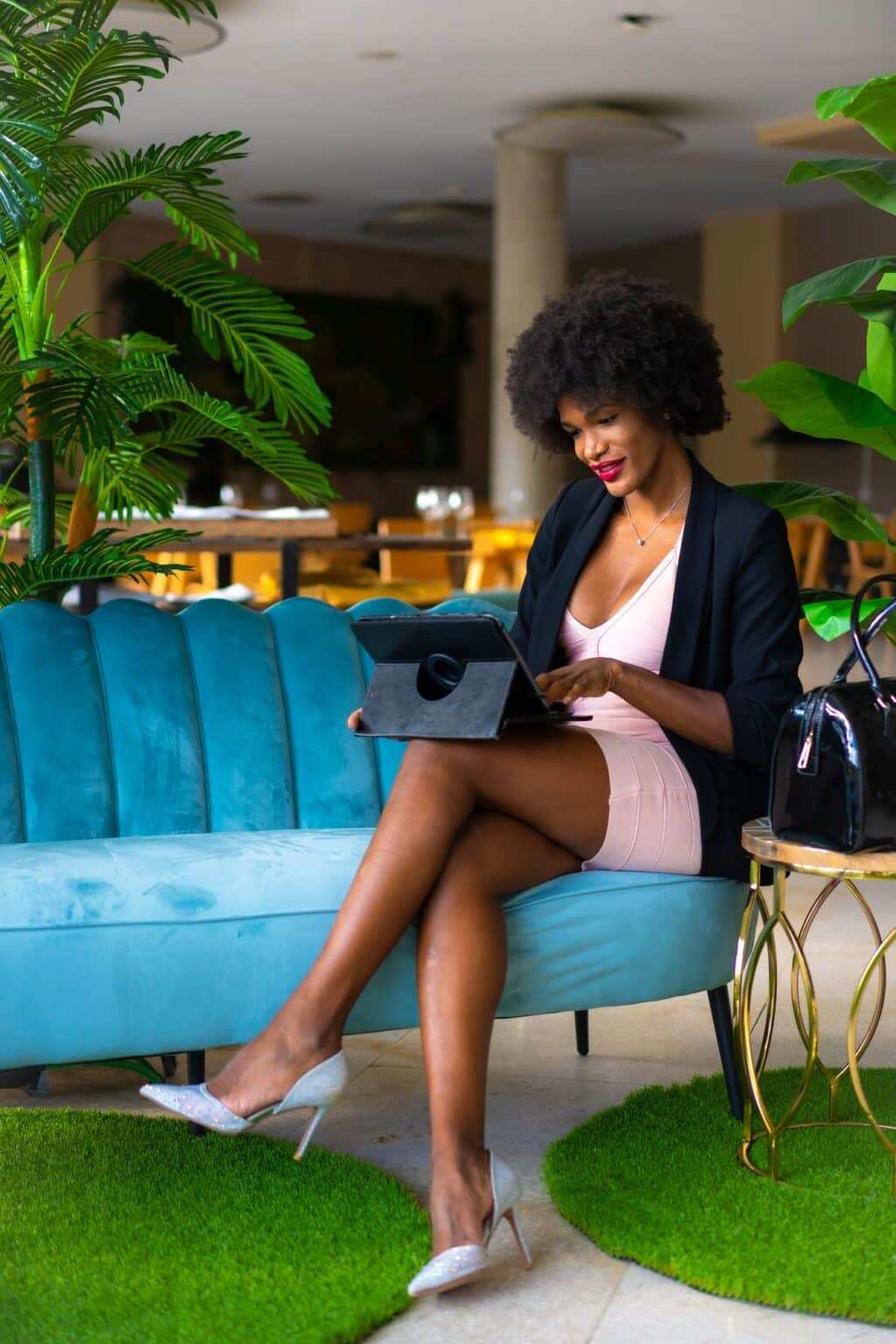 Young entrepreneur of black race and afro hair making a video call of a work meeting