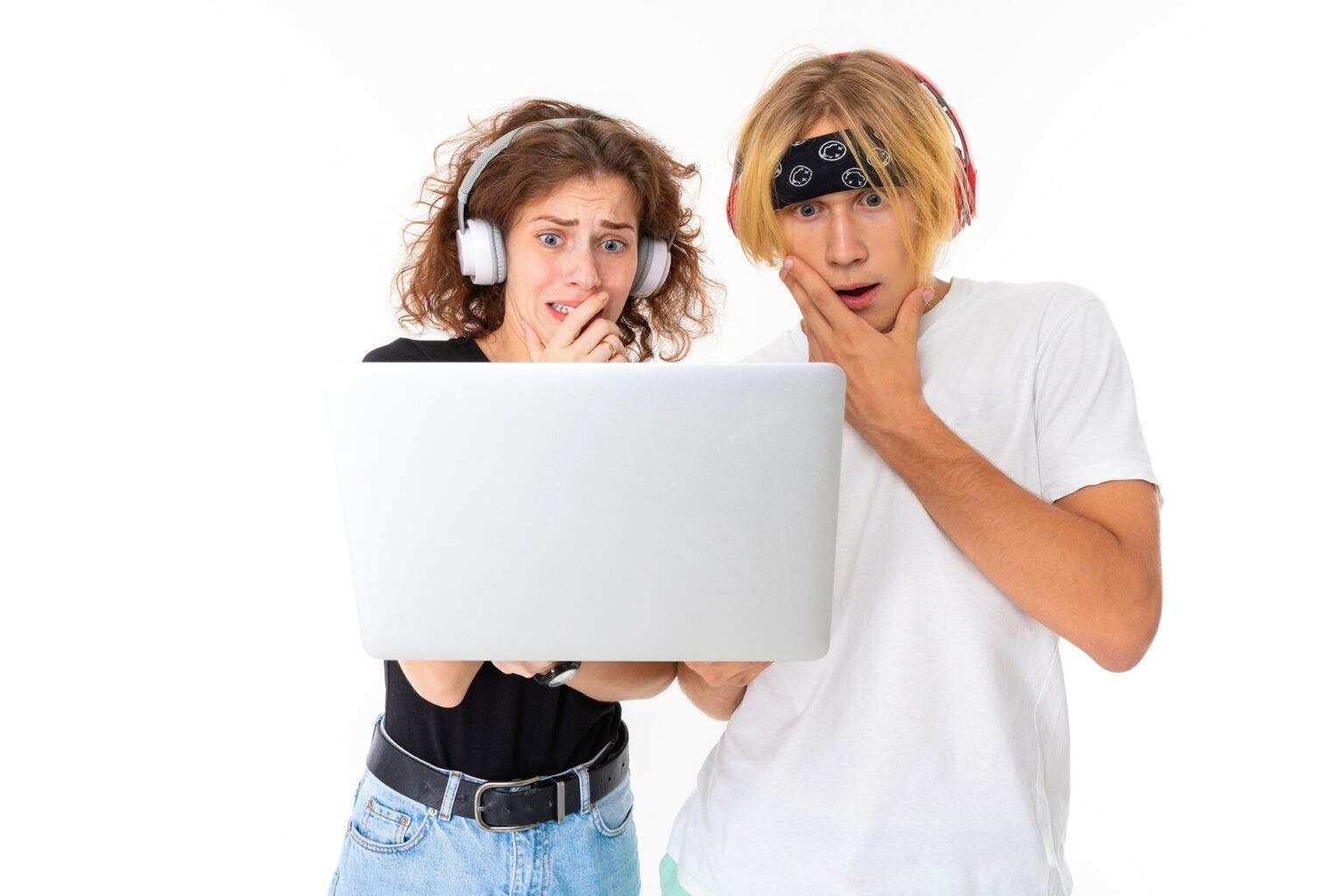 Stylish caucasian blonde man and young woman watch an interesting film or serial and listen to music