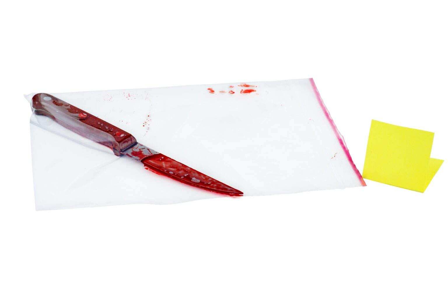 Kitchen knife covered with blood in plastic zip-lock packet isolated on white background
