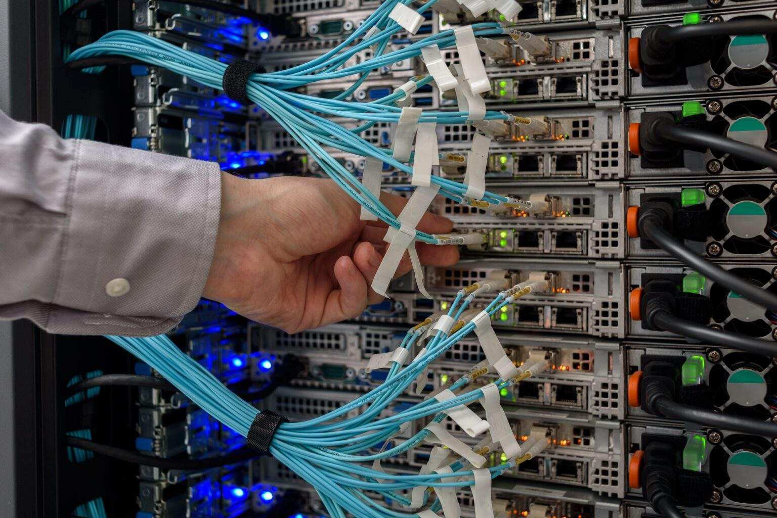 Man data center technician performing server maintenance