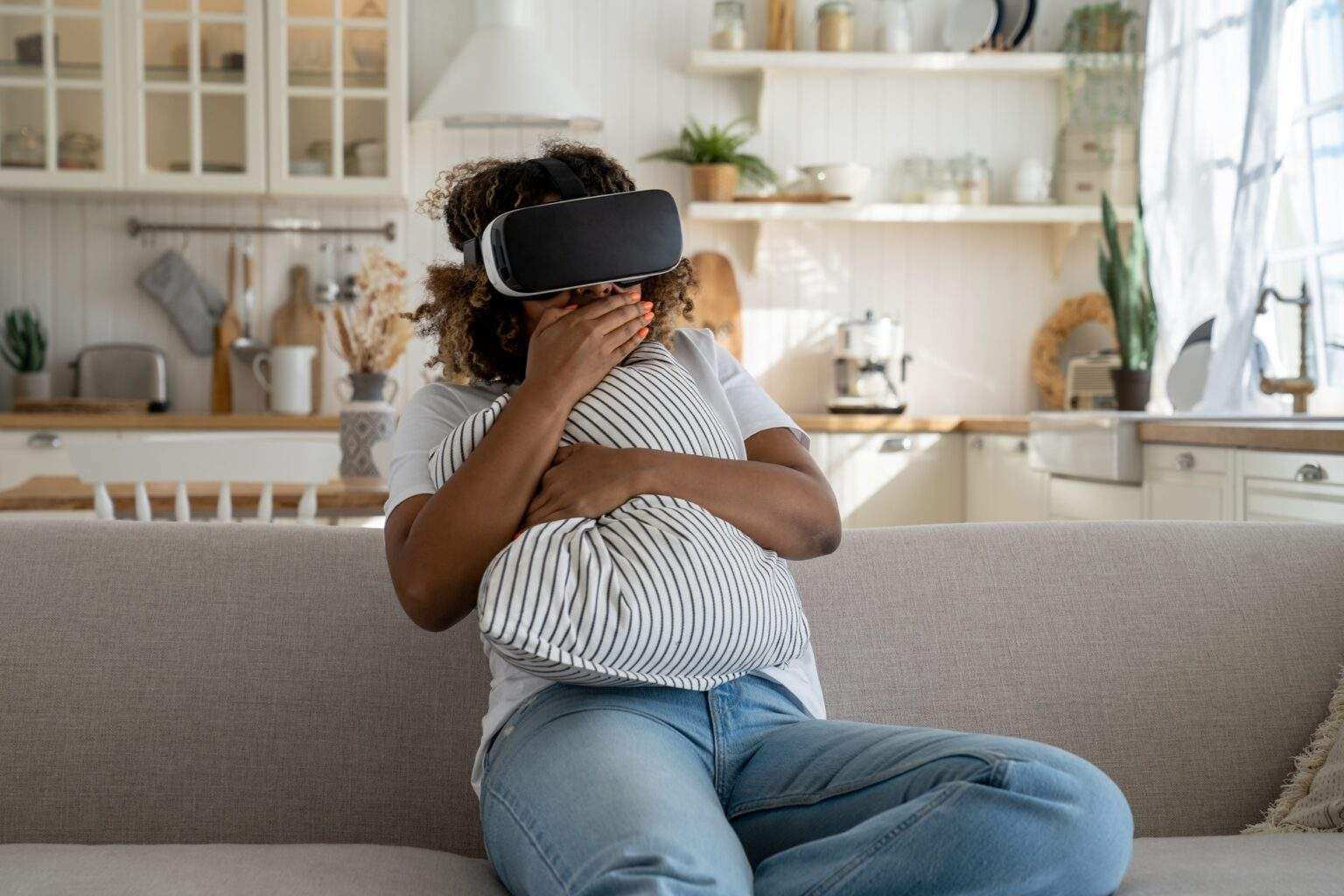 Shocked African American woman in virtual reality goggles feel scared while watching horror VR video